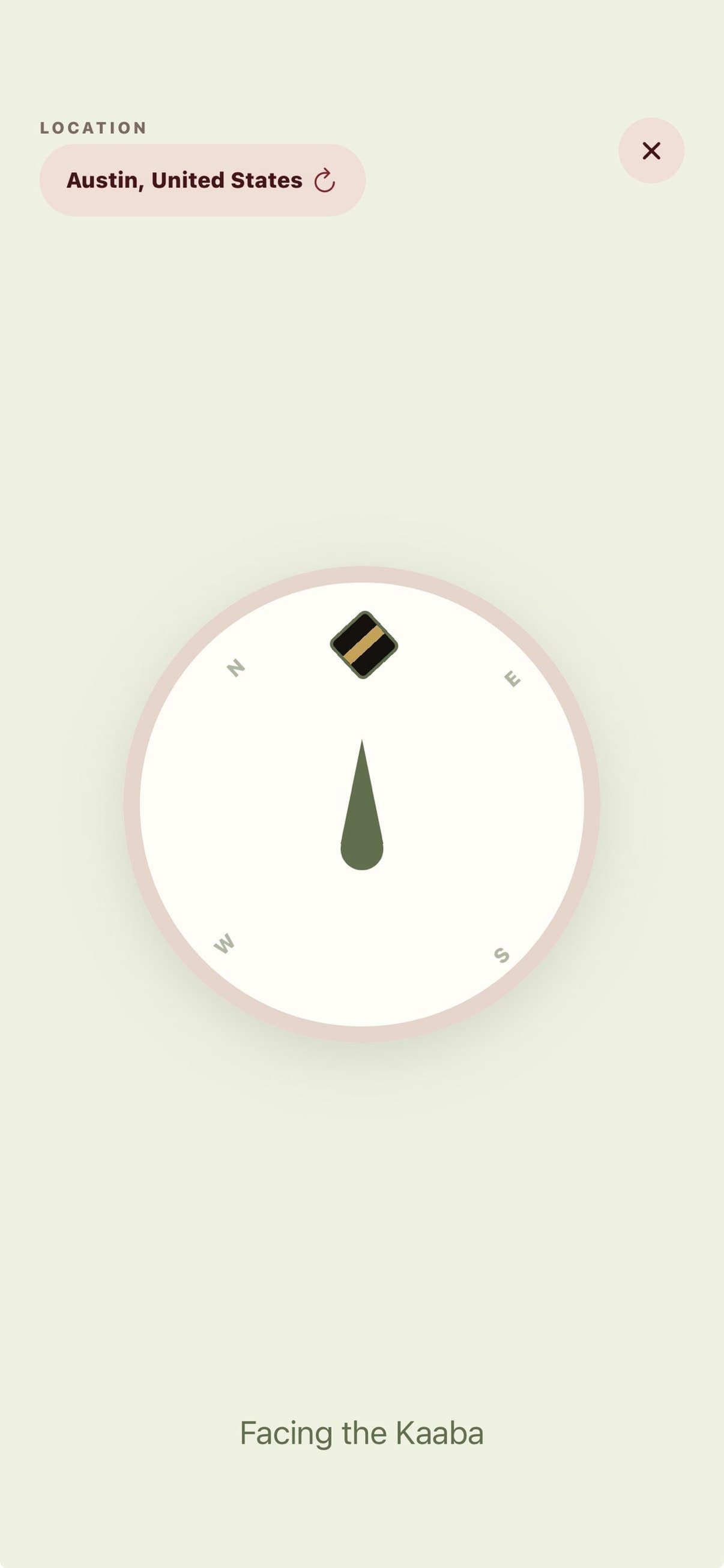 Qibla compass with the Kaaba at the top of the dial, reading Facing the Kaaba